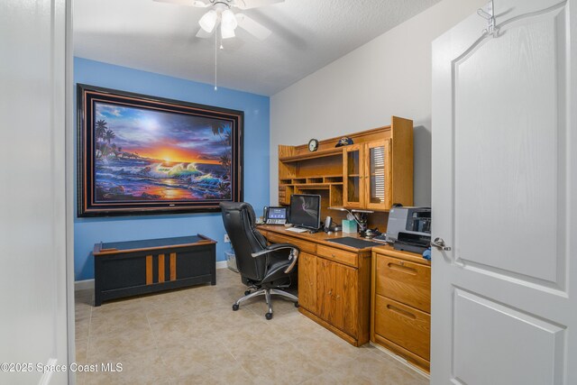 home office with baseboards, a ceiling fan, and light tile patterned flooring