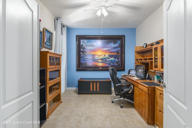 office featuring baseboards and a ceiling fan