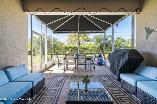 view of patio featuring outdoor dining area, a lanai, and an outdoor hangout area