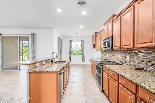 3485 Sansome Cir, Melbourne, FL 32940 - kitchen with a sink, stainless steel appliances, brown cabinets, backsplash, and light stone counters