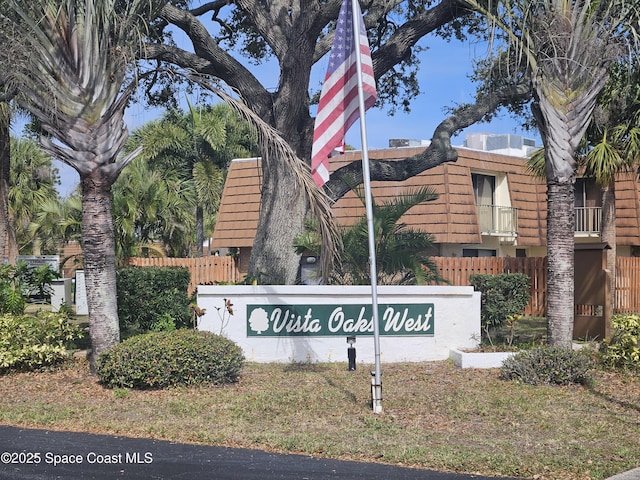 community / neighborhood sign with fence