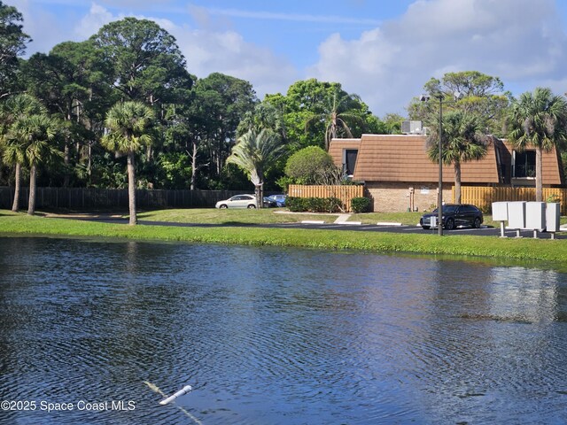 property view of water featuring fence