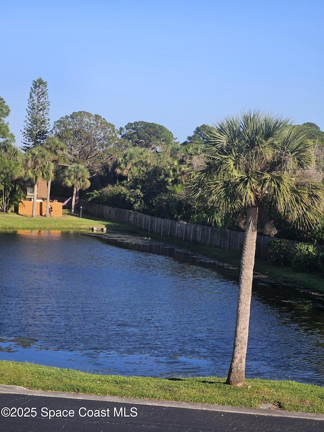 property view of water featuring fence