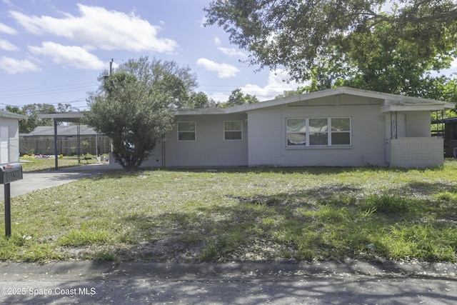 view of front facade with a carport and a front yard