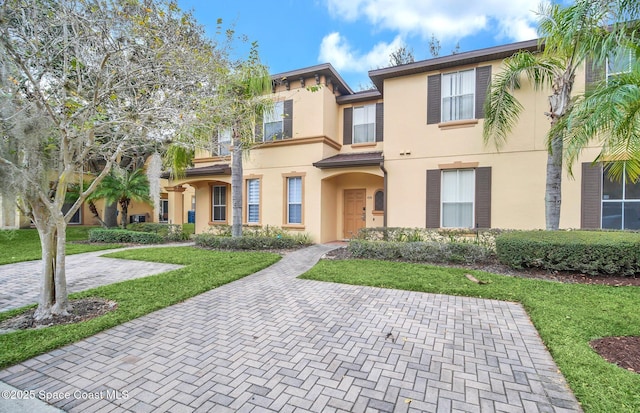 view of front of home featuring a front yard and stucco siding