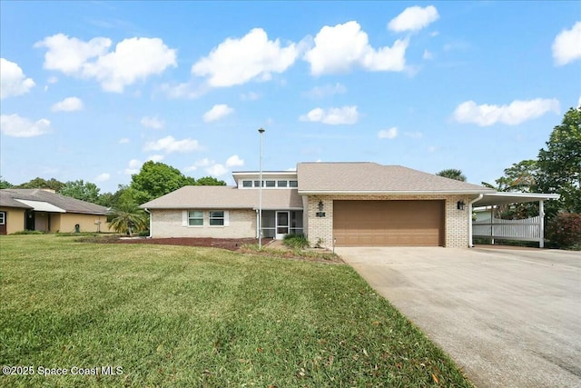 view of front of home featuring a garage, brick siding, driveway, and a front lawn