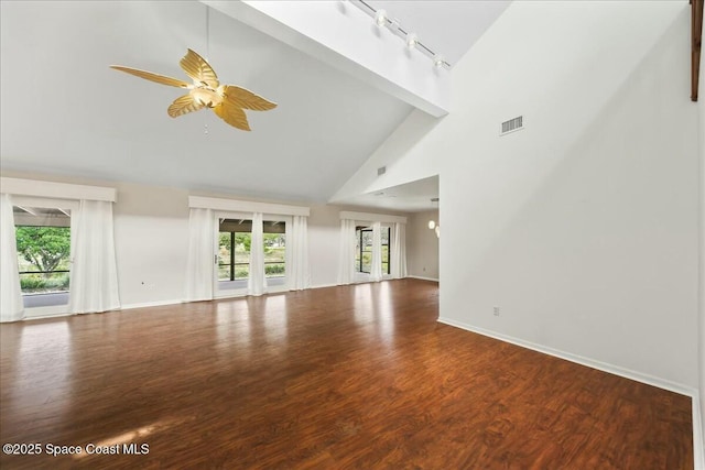 unfurnished living room with plenty of natural light, wood finished floors, and a ceiling fan