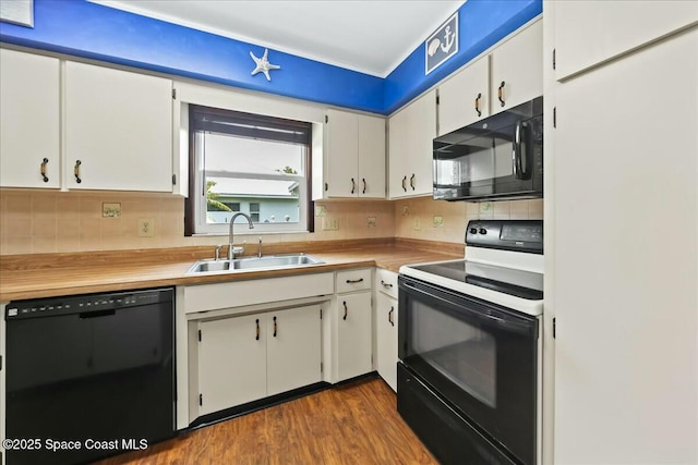 kitchen with white cabinetry, a sink, backsplash, and black appliances