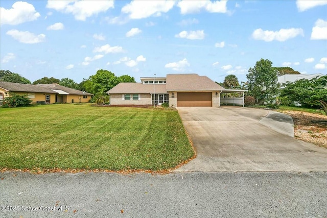 view of front of home featuring a garage, brick siding, driveway, and a front yard