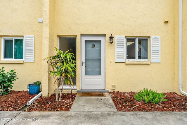 doorway to property with stucco siding