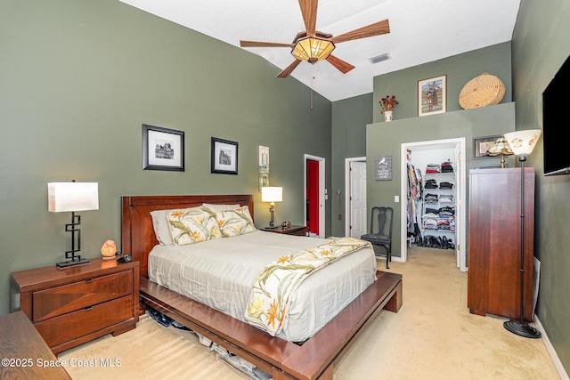 carpeted bedroom featuring high vaulted ceiling, visible vents, a ceiling fan, a spacious closet, and a closet