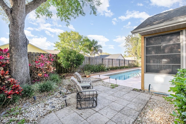 view of pool featuring a patio and a fenced backyard