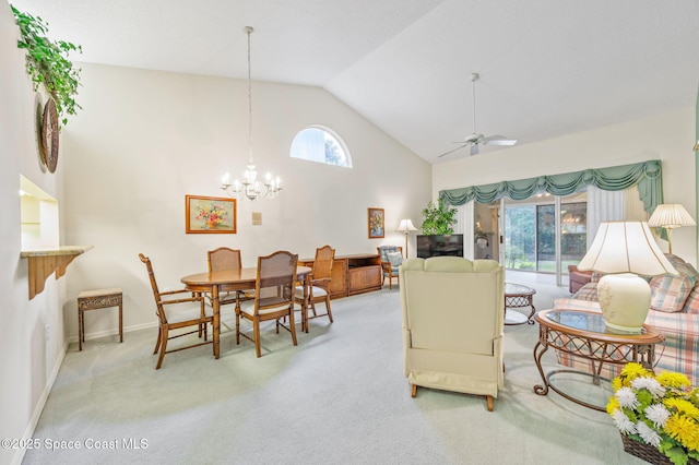 living room featuring baseboards, high vaulted ceiling, carpet flooring, and ceiling fan with notable chandelier