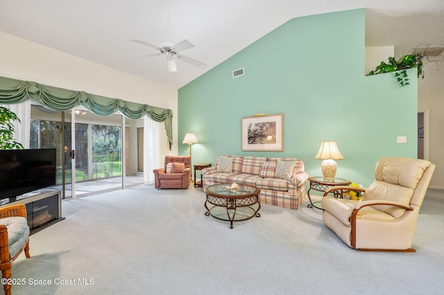 living area featuring high vaulted ceiling, carpet, visible vents, and a ceiling fan