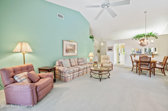 carpeted living room with high vaulted ceiling, visible vents, and ceiling fan with notable chandelier