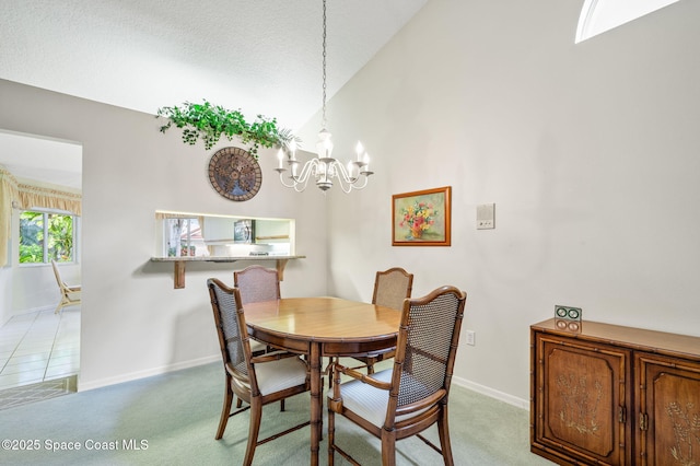 dining room featuring lofted ceiling, baseboards, a notable chandelier, and light colored carpet