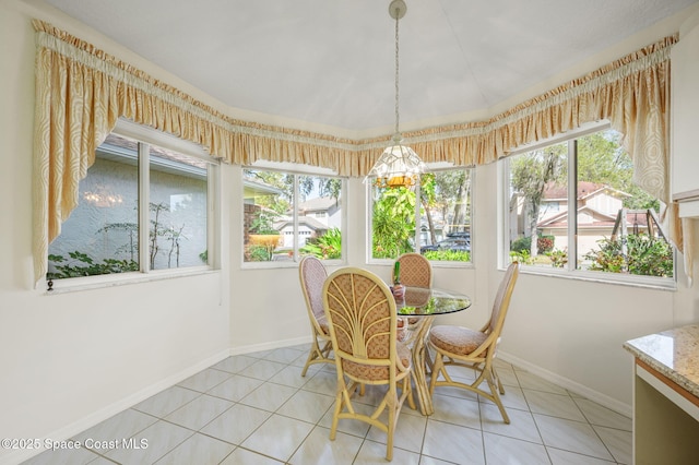 sunroom / solarium with an inviting chandelier