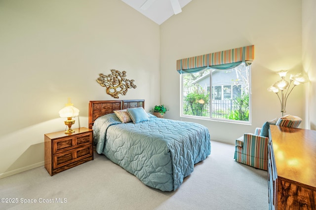 bedroom featuring high vaulted ceiling and carpet flooring