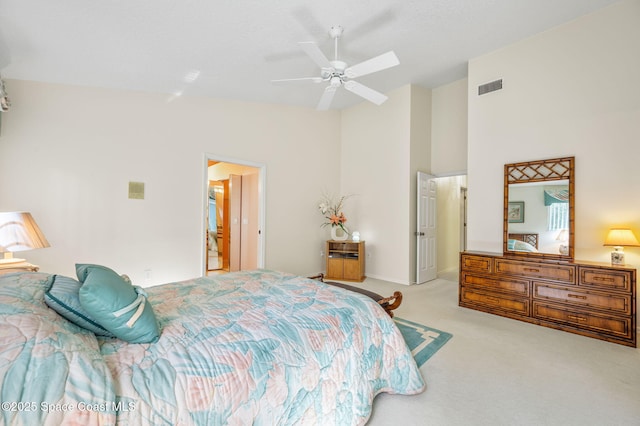 bedroom with ceiling fan, high vaulted ceiling, visible vents, and light colored carpet