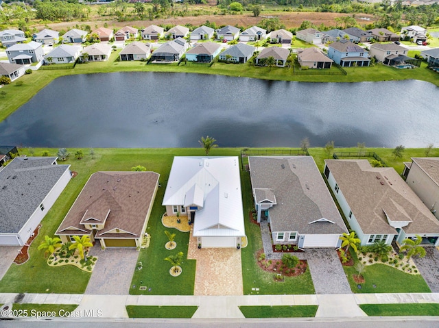 birds eye view of property with a water view and a residential view