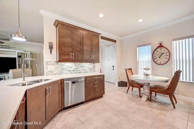 kitchen with tasteful backsplash, light countertops, crown molding, stainless steel dishwasher, and a sink