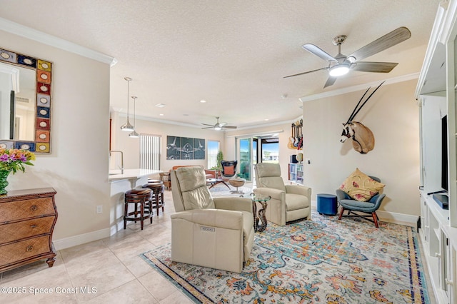 living room with light tile patterned floors, baseboards, ornamental molding, and a textured ceiling