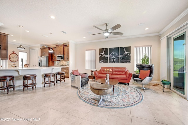 living room featuring light tile patterned floors, ornamental molding, a textured ceiling, and recessed lighting