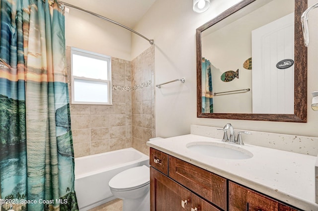 full bathroom featuring toilet, shower / bathtub combination with curtain, and vanity