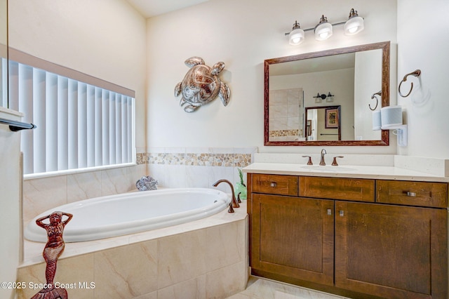 bathroom with a garden tub and vanity