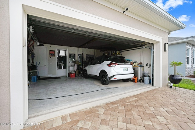 garage featuring decorative driveway