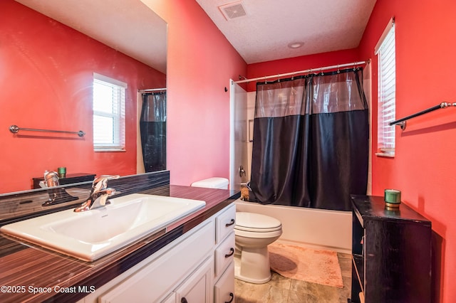 full bath featuring shower / bath combo, visible vents, toilet, a textured ceiling, and vanity