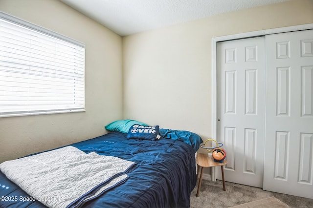 bedroom with carpet floors and a closet