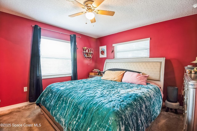 bedroom featuring carpet floors, a ceiling fan, baseboards, and a textured ceiling