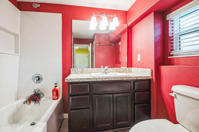 bathroom featuring toilet, a textured wall, shower / bathing tub combination, and vanity