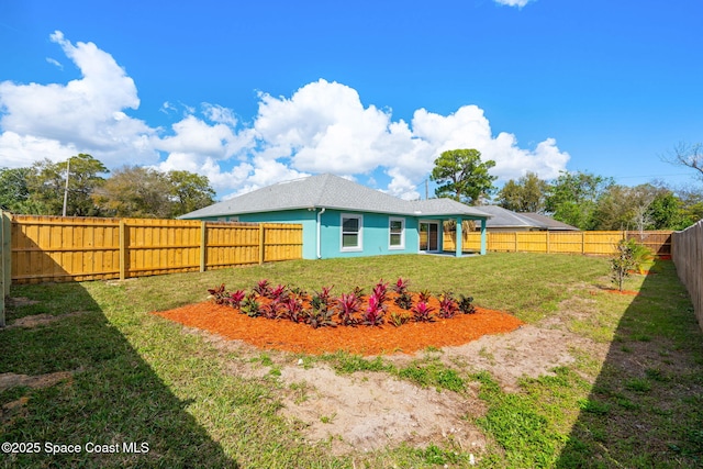 view of yard with a fenced backyard