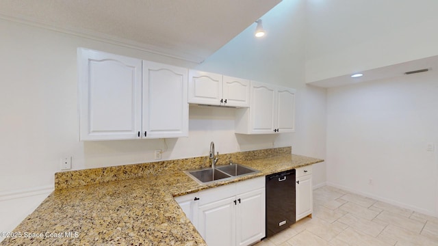 kitchen featuring light stone counters, white cabinetry, a sink, dishwasher, and baseboards