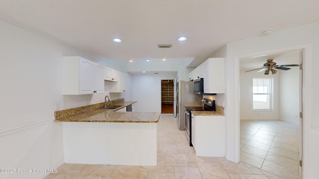 kitchen featuring appliances with stainless steel finishes, a sink, visible vents, and white cabinetry