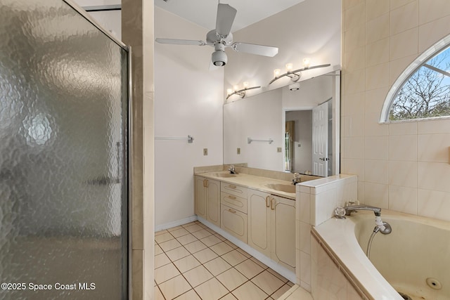 bathroom with a garden tub, double vanity, lofted ceiling, a shower stall, and tile patterned flooring