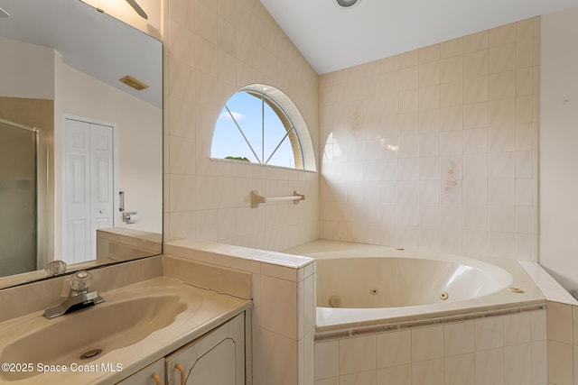 full bath featuring lofted ceiling, visible vents, a shower stall, vanity, and a whirlpool tub