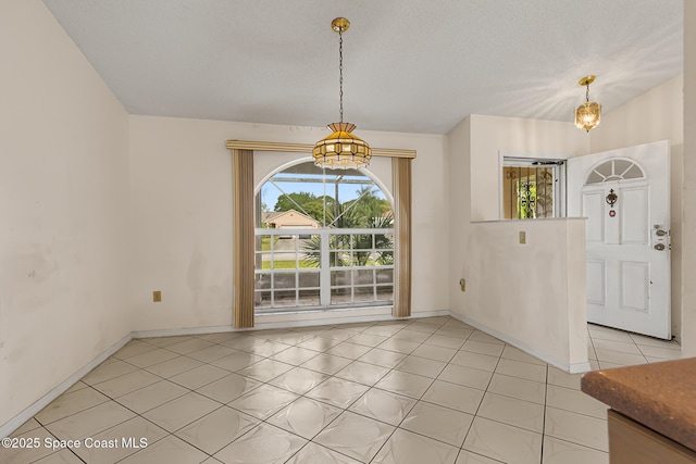 unfurnished dining area featuring light tile patterned floors, an inviting chandelier, and baseboards