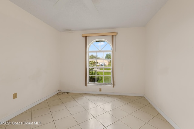 unfurnished room with baseboards