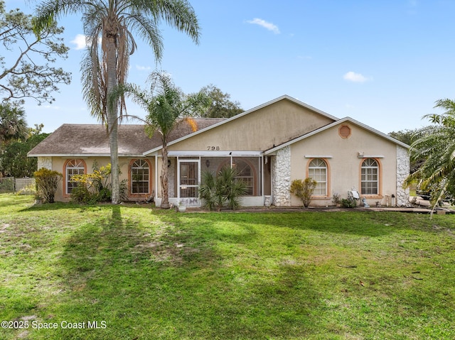 ranch-style house with fence, a front lawn, and stucco siding