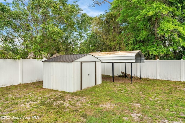 view of shed with a detached carport and a fenced backyard