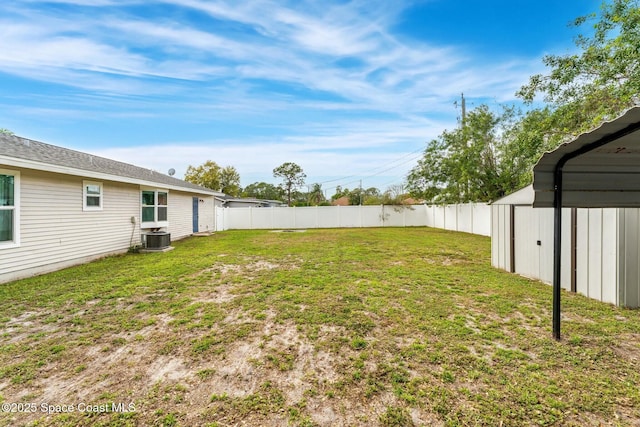 view of yard featuring an outbuilding, central AC, a storage unit, and a fenced backyard