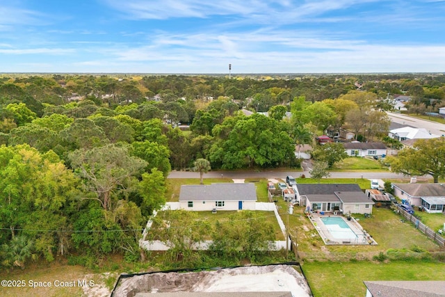 birds eye view of property featuring a residential view and a wooded view