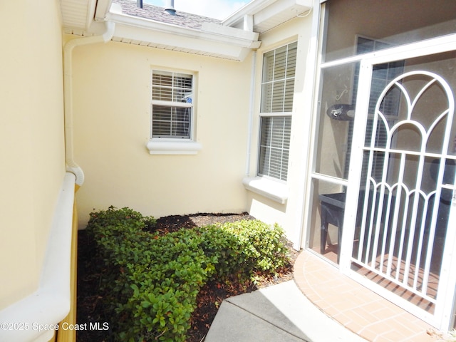 4590 Brantford Ct, Rockledge, FL 32955 - view of exterior entry featuring stucco siding and roof with shingles
