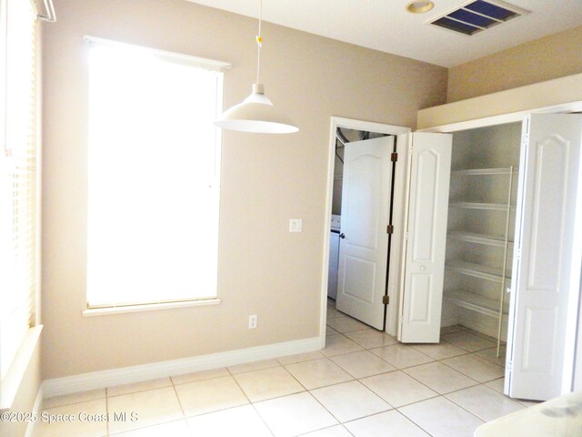4590 Brantford Ct, Rockledge, FL 32955 - unfurnished dining area with light tile patterned flooring and baseboards