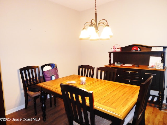 4590 Brantford Ct, Rockledge, FL 32955 - dining room with a chandelier, wood finished floors, and baseboards