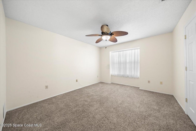 carpeted empty room featuring ceiling fan and a textured ceiling