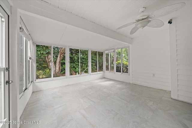 unfurnished sunroom featuring ceiling fan